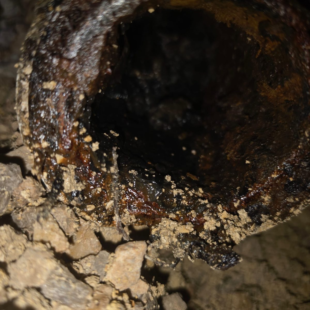 Inside of a corroded, failing cast iron sewer line