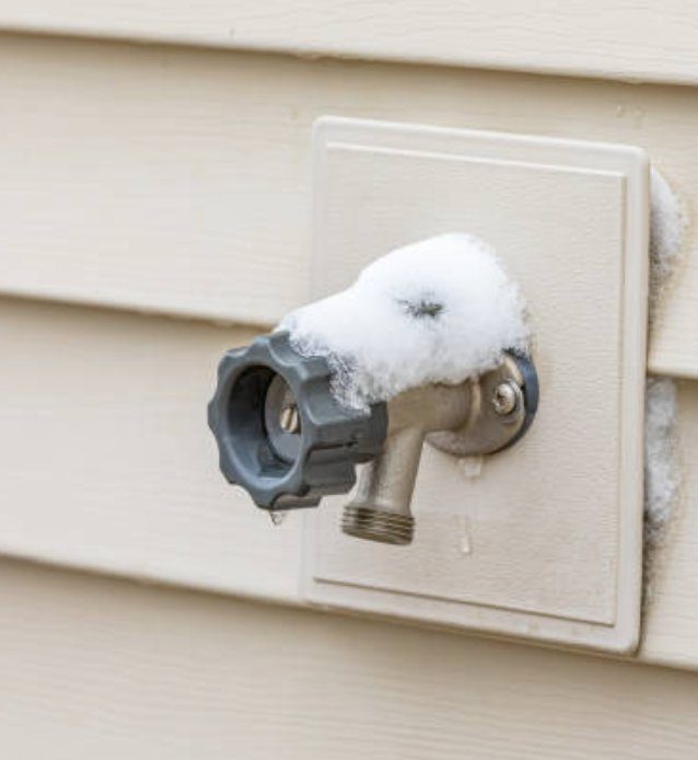 Snow-covered outdoor faucet during a Texas freeze